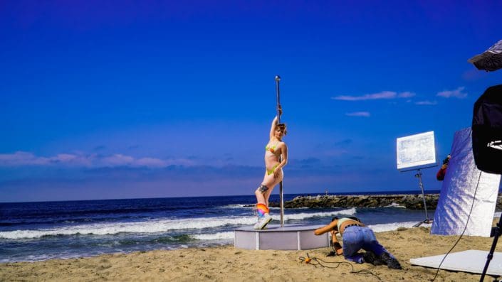 Model poses on all star stages portable dance pole on the beach during a photo shoot 2-2