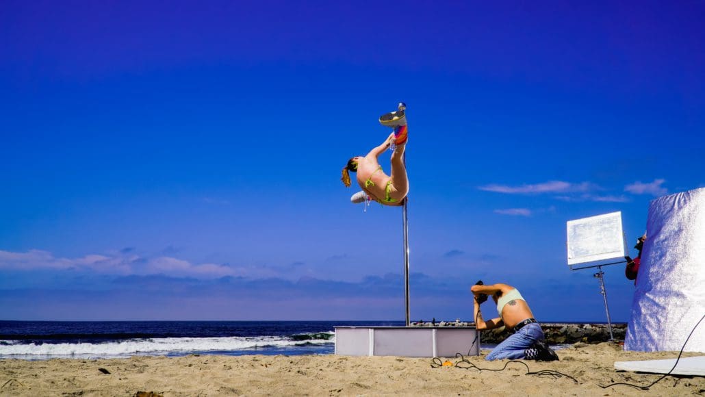 Photographer shoots pole dancer doing splits on an all star stages portable dance pole on the beach-2 Photographer shoots pole dancer doing splits on an all star stages portable dance pole on the beach-2