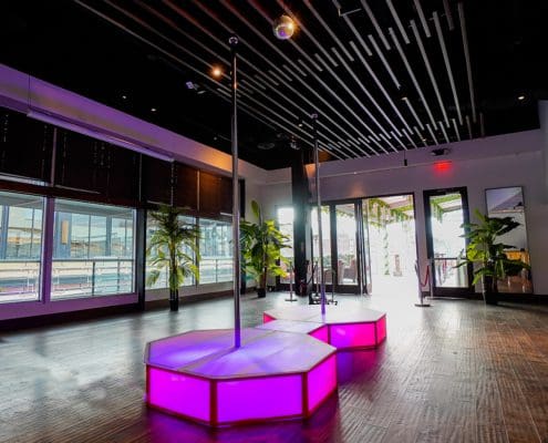 all star stages amazing pink double portable stripper pole and glow stage on wood floor in fancy restaurant 1000px