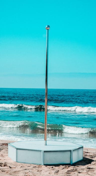 all star stages frosted portable stage and stripper pole on the beach with teal tinted sky and ocean all star stages frosted portable stage and stripper pole on the beach with teal tinted sky and ocean
