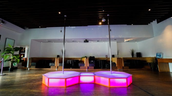 pink all star stages portable double stage and dance pole in restaurant in santa monica 1000px