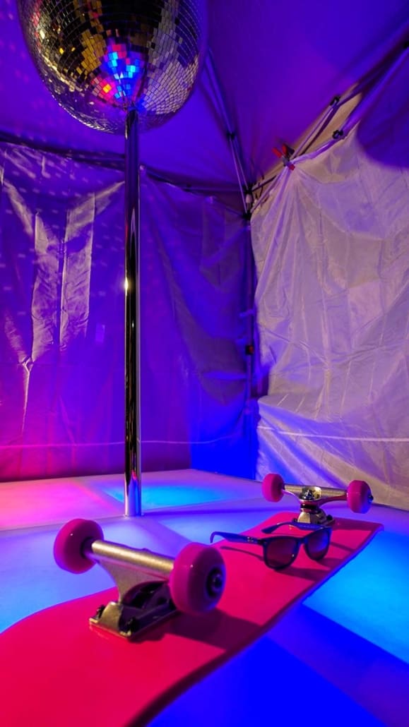 all star stages custom acrylilc glow furniture 6x4 stage with spinning 45mm dance pole and pink skateboard closeup of purple glow with the board and rayban sunglasses