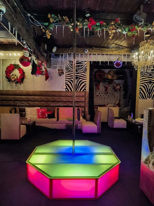 all star stages x glow stage with spinning pole in pink yellow top glow center