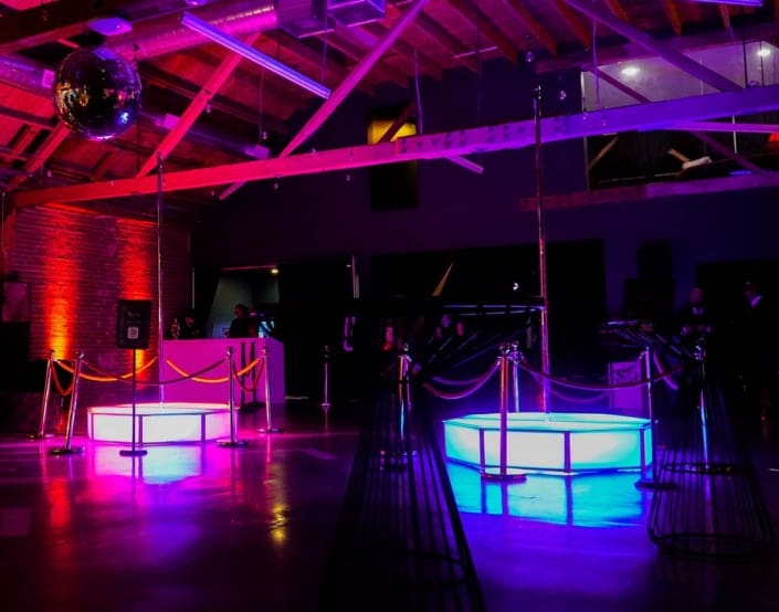 all star stages x twin set at night glowing pink and blue with pro spinning stripper poles