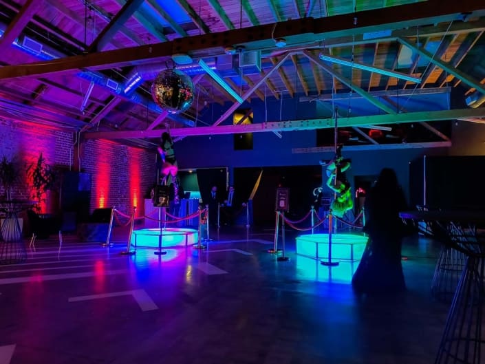 dancers warm up and pose on an all star stages x spinning dance pole octo acrylic led pole dance stages